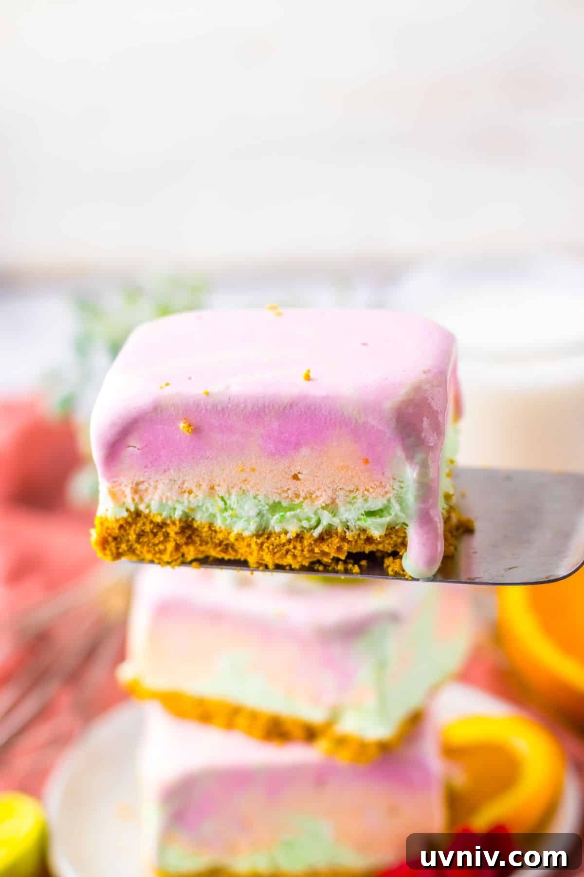 No-Bake Rainbow Sherbet Dessert Bars 3 Slice of rainbow sherbet bar on a spatula.
