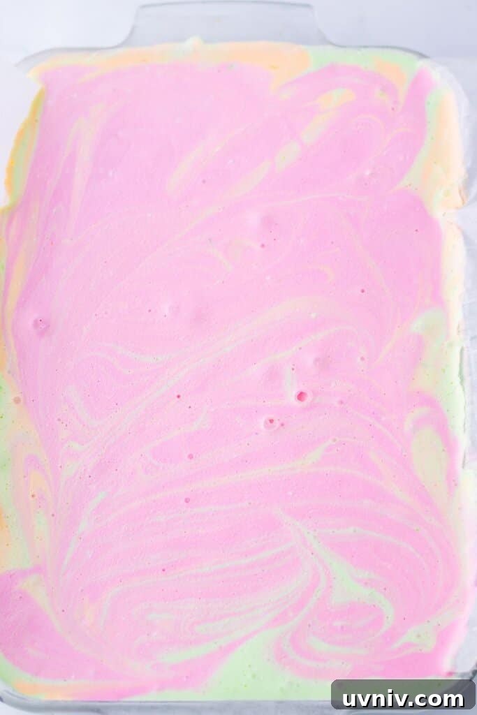 No-Bake Rainbow Sherbet Dessert Bars 8 Swirl design in a dessert in a glass baking dish.