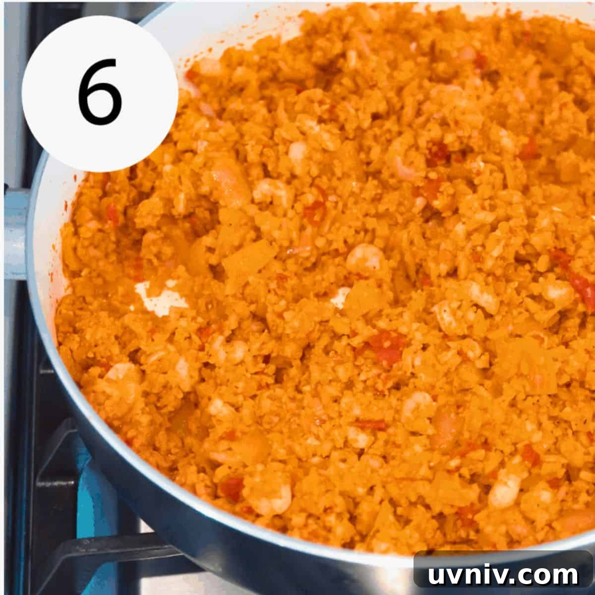Spanish Cauliflower Rice with Shrimp — Quick Low-Carb Recipe 9 A pan filled with tomato cauliflower rice with shrimp in it.