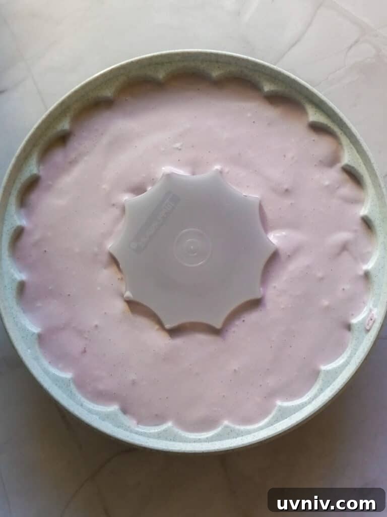 Amish Grape Jello Salad with Cream Cheese—Classic Recipe 4 putting jello in a mold