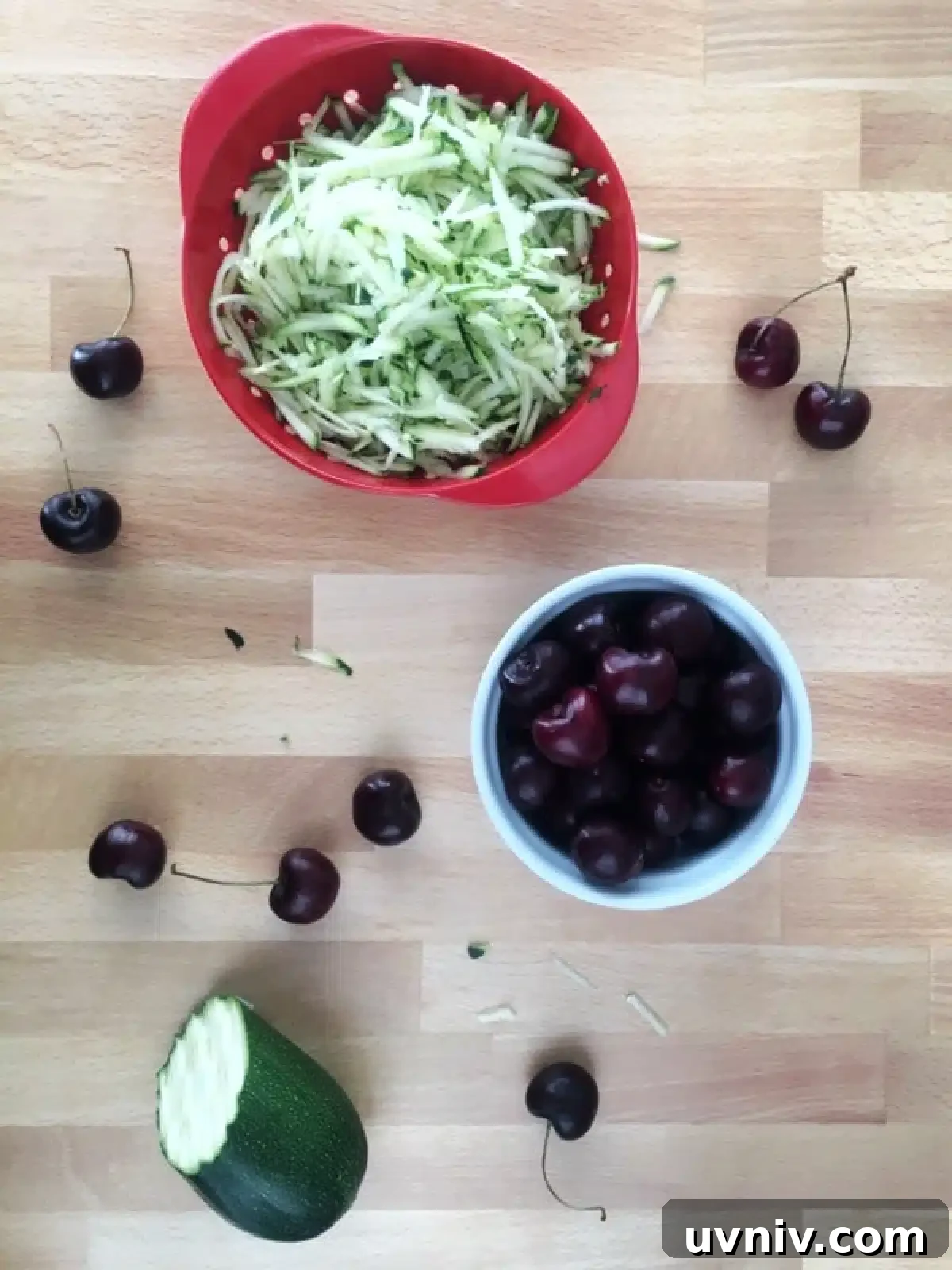 Cherry Zucchini Crumb Muffins @spabettie #glutenfree #vegan How to make cherry zucchini muffins: bowls of fresh grated zucchini and pitted cherries on a butcher block.