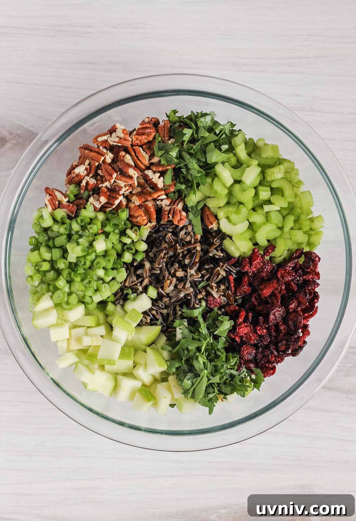 Wild Rice Salad with Cranberries & Pecans — Chilled Side Dish 8 Wild rice salad ingredients in glass mixing bowl before being mixed together.