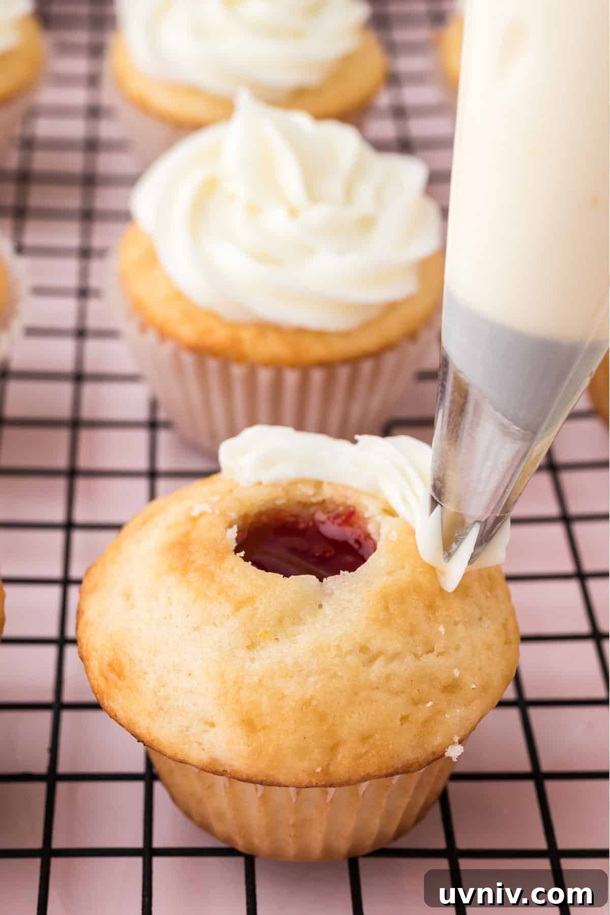 Adding the frosting to the cupcakes with a pastry bag.