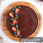 French Chocolate Ganache Tart Recipe: Rich, Silky Dessert Guide 9 Chocolate Tart from above on a round wooden board.