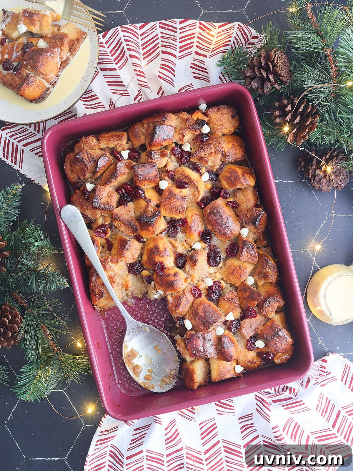 White Chocolate Cranberry Bread Pudding Recipe for Holidays 2 Pan of white chocolate cranberry bread pudding with a slice removed.
