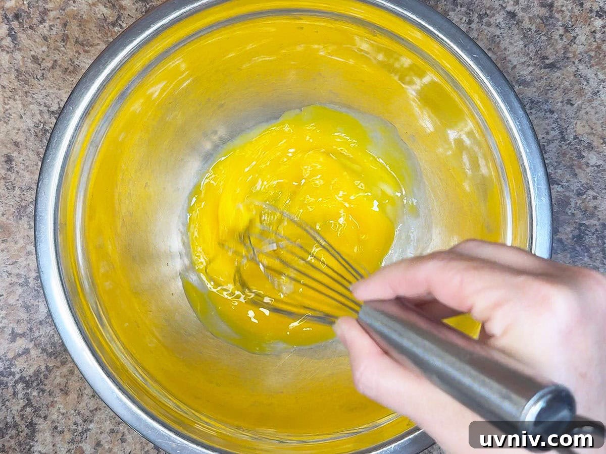 White Chocolate Cranberry Bread Pudding Recipe for Holidays 11 Whisking egg yolks for the creme anglaise.
