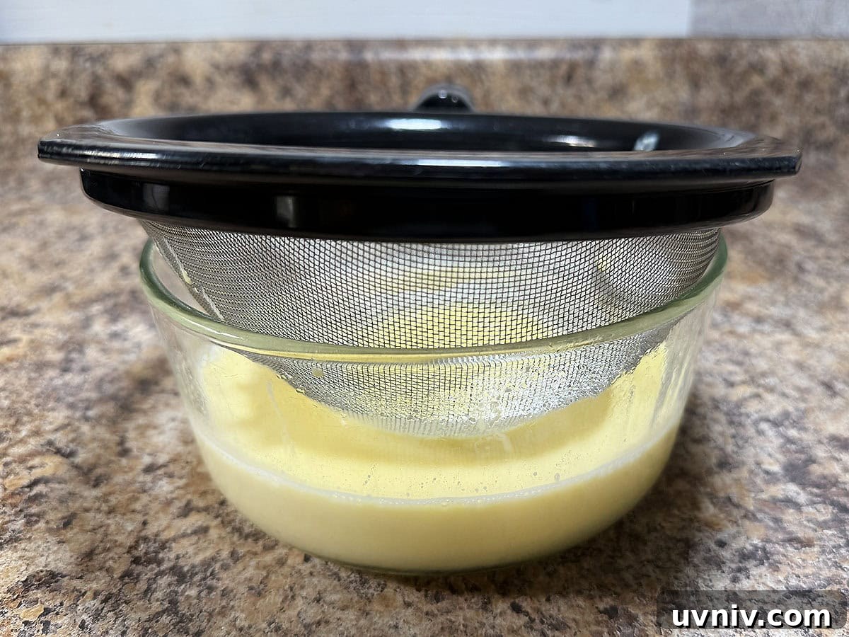 White Chocolate Cranberry Bread Pudding Recipe for Holidays 14 Straining the creme anglaise through a mesh strainer.