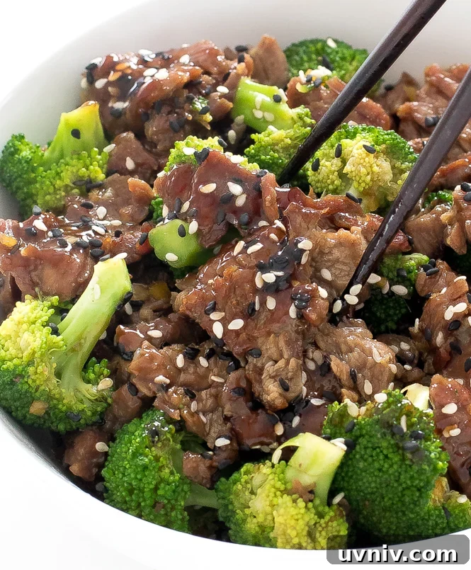 20 Minute Beef and Broccoli | chefsavvy.com beef and broccoli in white bowl with chopsticks