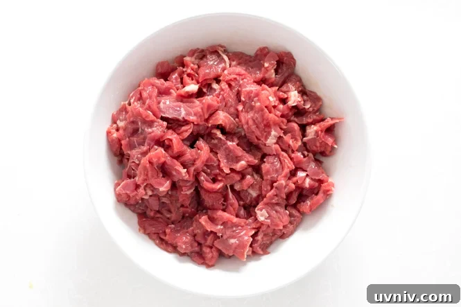 Quick Beef and Broccoli Stir-Fry in 20 Minutes 2 marinating steak in white bowl