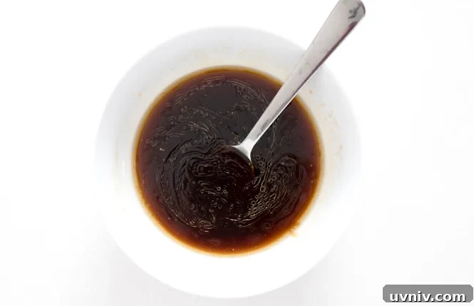 Quick Beef and Broccoli Stir-Fry in 20 Minutes 3 mixing oyster sauce, beef broth and sesame oil in white bowl