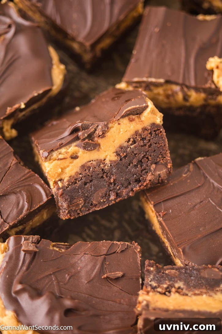 Ultra-fudgy Buckeye Brownies with a creamy peanut butter layer + glossy chocolate topping. A Nostalgic chocolate-PB dessert everyone loves. #buckeyerecipes #brownies Slices of Buckeye Brownies with a creamy peanut butter layer and glossy chocolate topping.