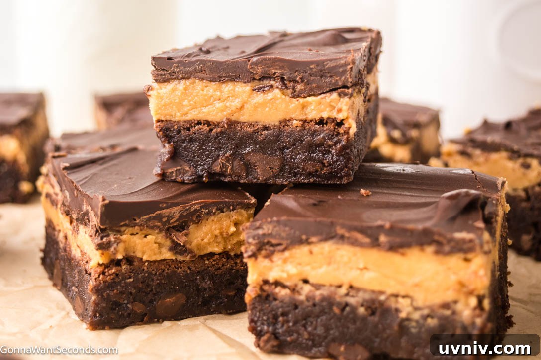 Ultra-fudgy Buckeye Brownies with a creamy peanut butter layer + glossy chocolate topping. A Nostalgic chocolate-PB dessert everyone loves. #buckeyerecipes #brownies Slices of Buckeye Brownies with a creamy peanut butter layer and glossy chocolate topping