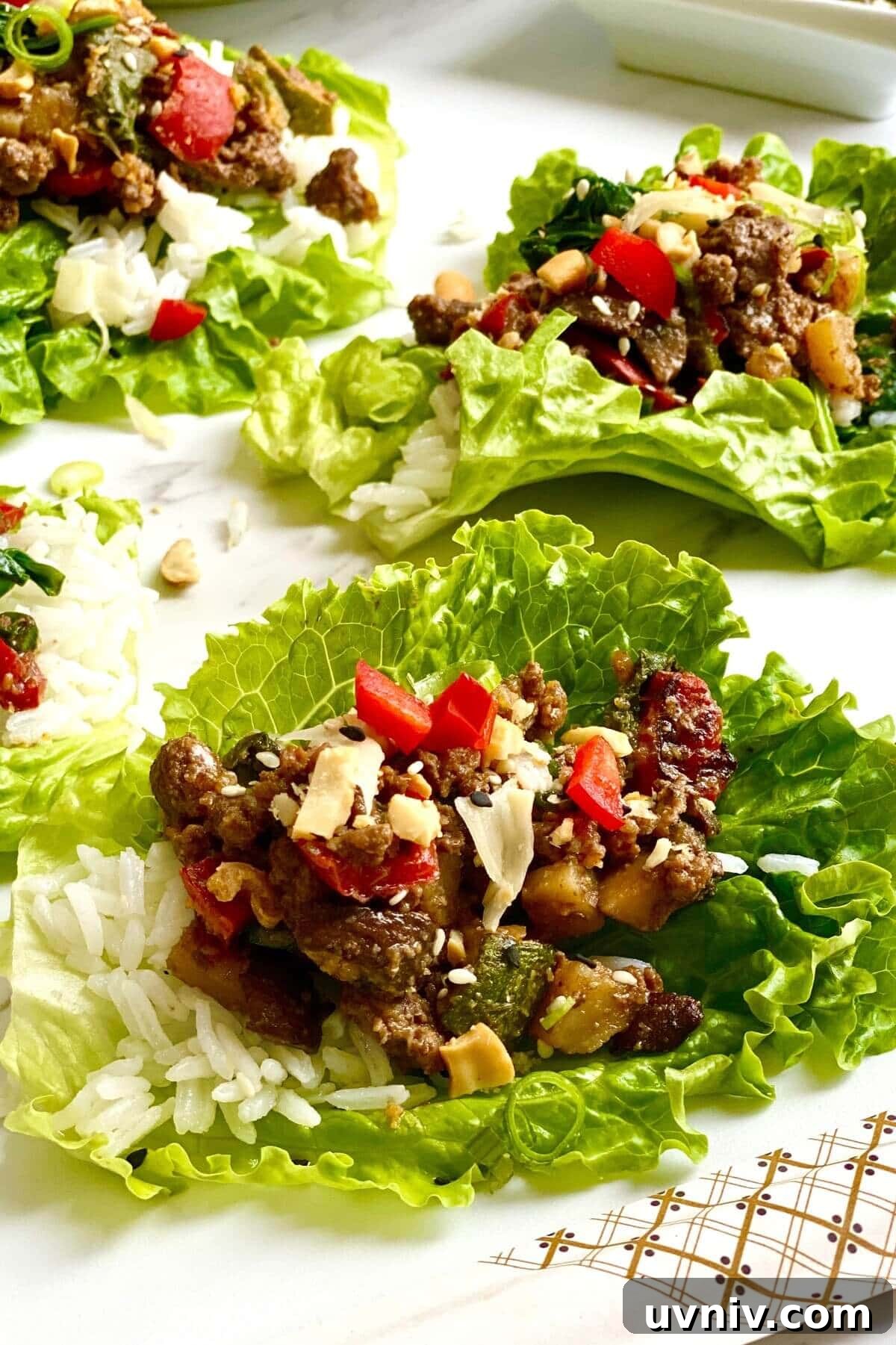 Savory Ground Beef Lettuce Wraps with Zesty Asian Sauce 2 lettuce cup filled with Korean beef and rice.