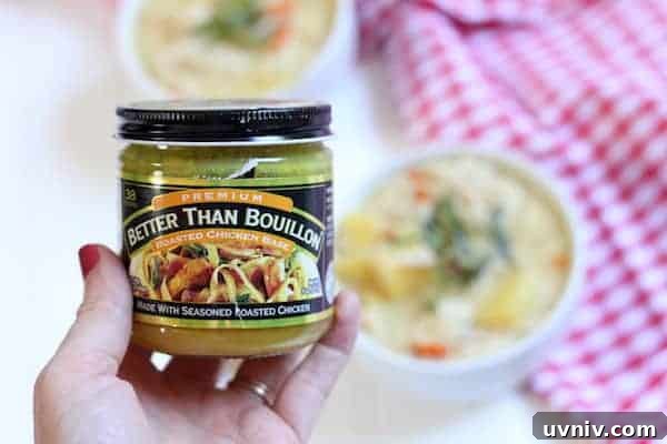 Image shows a hand holding a jar of Better Than Bouillion chicken base