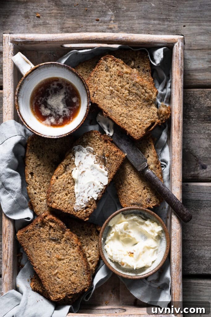 Irresistible Brown-Butter Banana Bread Recipe 3 Slices of banana bread next to cup of coffee.