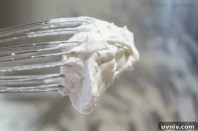 Garlic Herb Whipped Cream in Whisk