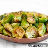 Crispy Sautéed Brussels Sprouts with Garlic and Parmesan 6 Square photo of a plate of sauteed Brussels sprouts
