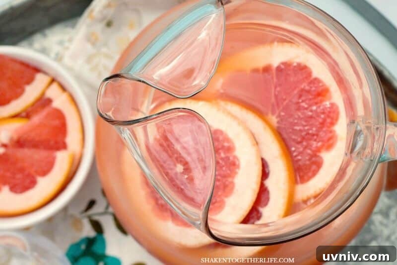 Ruby Red Grapefruit Mimosas in glass and pitcher