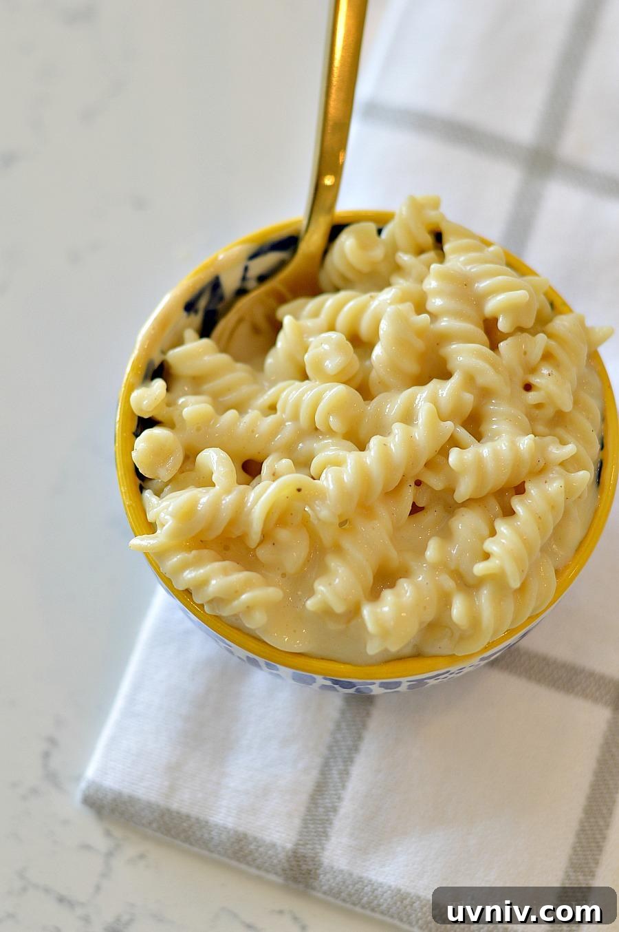 Instant Pot Gluten Free Mac and Cheese Overhead shot of gluten-free Mac and cheese in a bowl with gold spoon