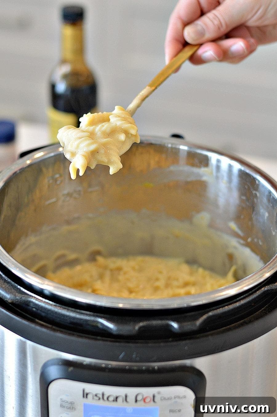 Gluten-free mac and cheese (Instant Pot) Creamy Mac and cheese being spooned out of an Instant Pot