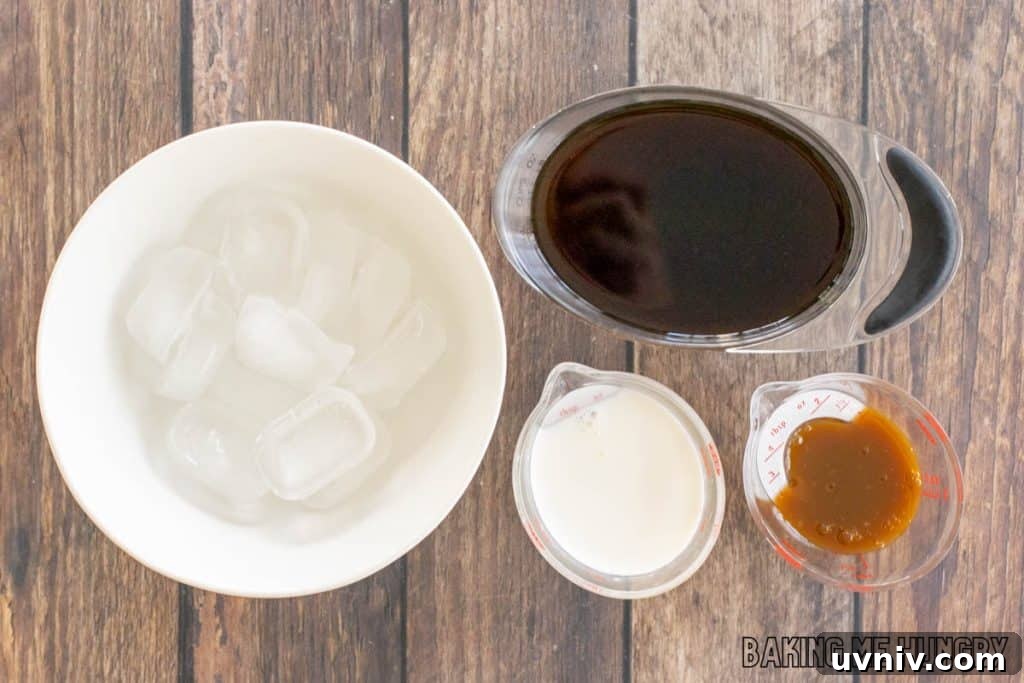 Creamy Caramel Iced Coffee Recipe You’ll Love 4 ingredients in small measuring cups next to bowl of ice
