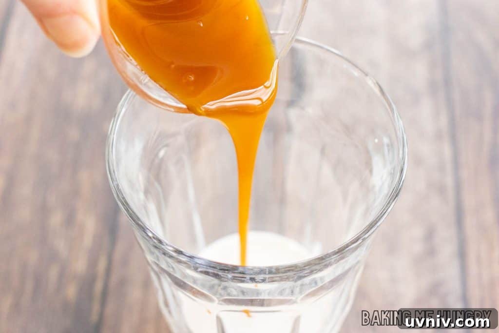 Creamy Caramel Iced Coffee Recipe You’ll Love 5 caramel syrup being added