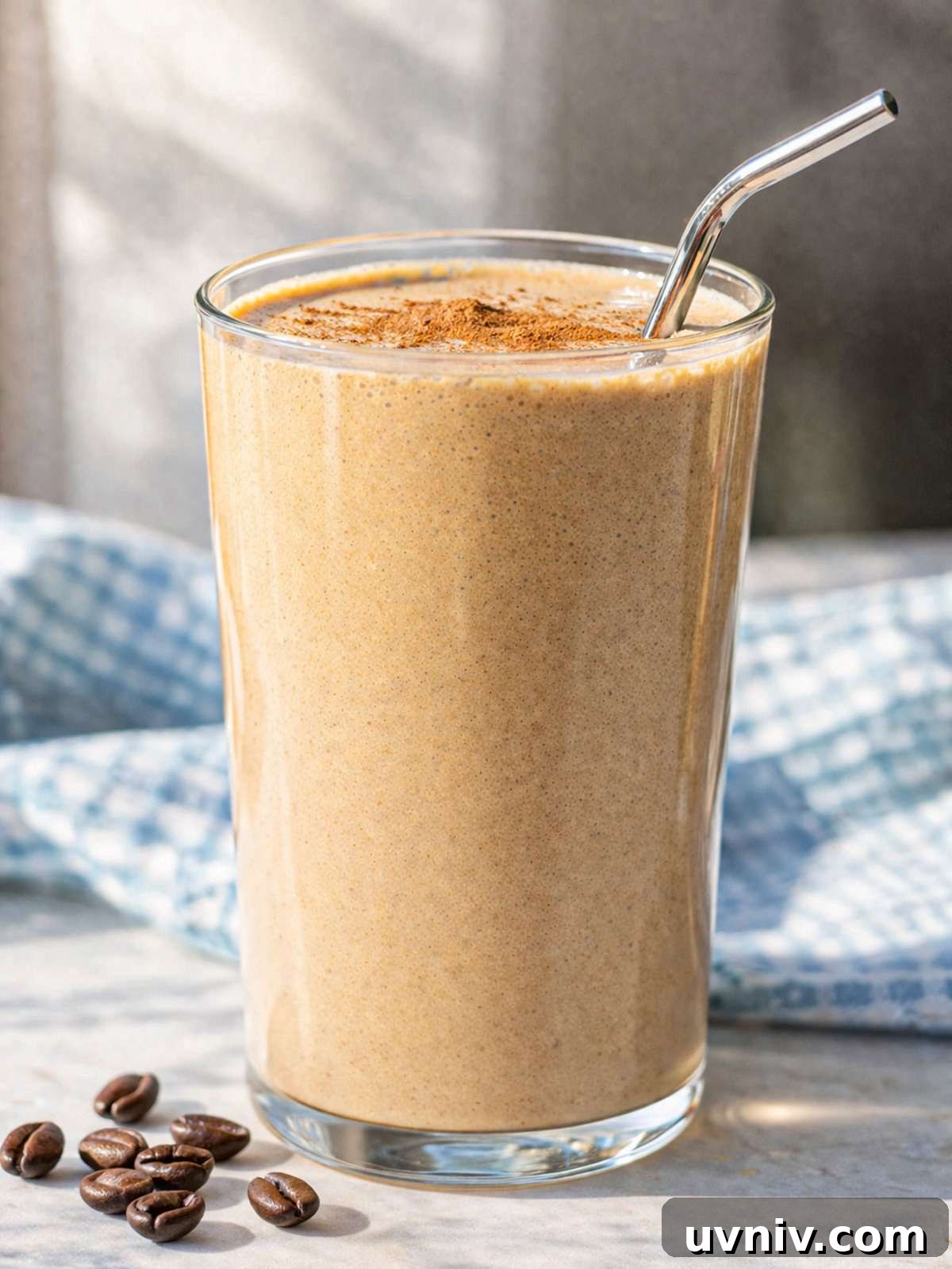 Iced Coffee Smoothie Recipe for a Morning Energy Boost 2 Close up of coffee smoothie showing thick creamy texture and light foam on top.