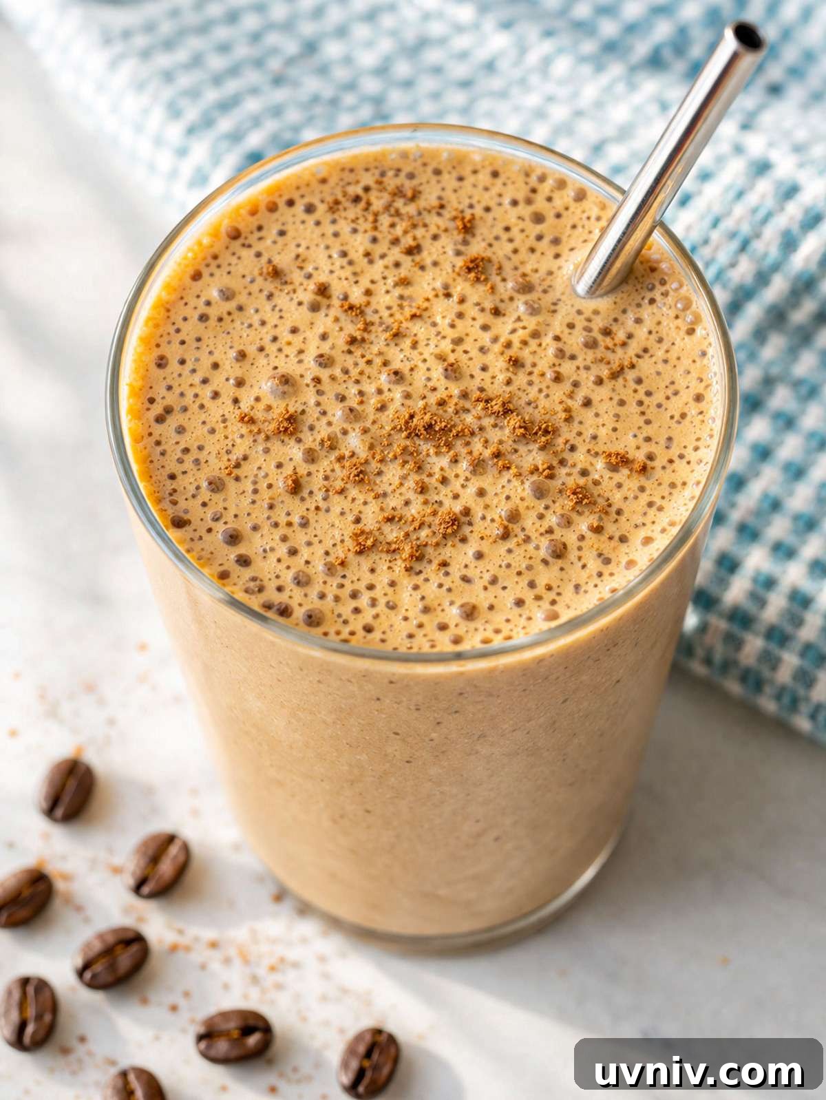 Iced Coffee Smoothie Recipe for a Morning Energy Boost 4 Coffee smoothie in glass on marble table with soft window light and creamy texture.