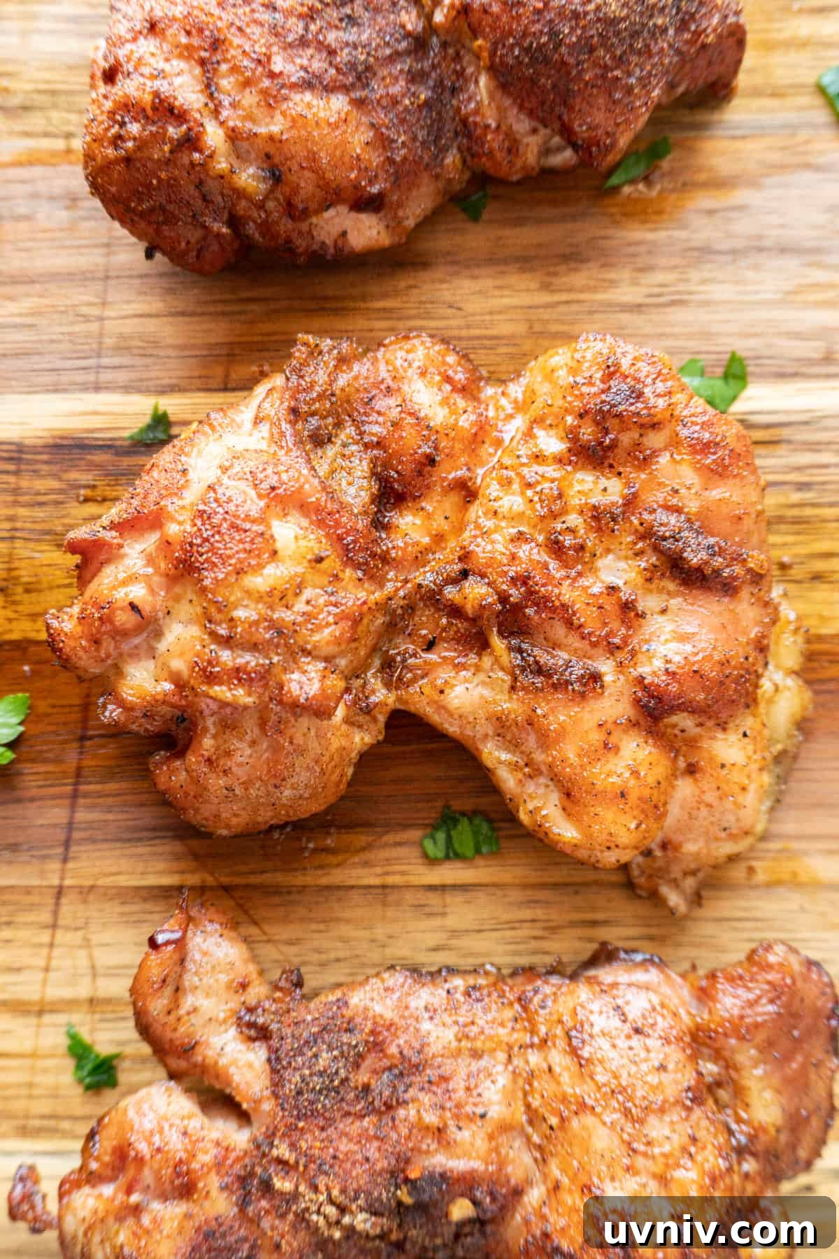 Juicy Smoked Chicken Thighs: Tender, Flavorful BBQ Recipe 2 close up of smoked chicken thigh0 boneless skinless- on cutting board