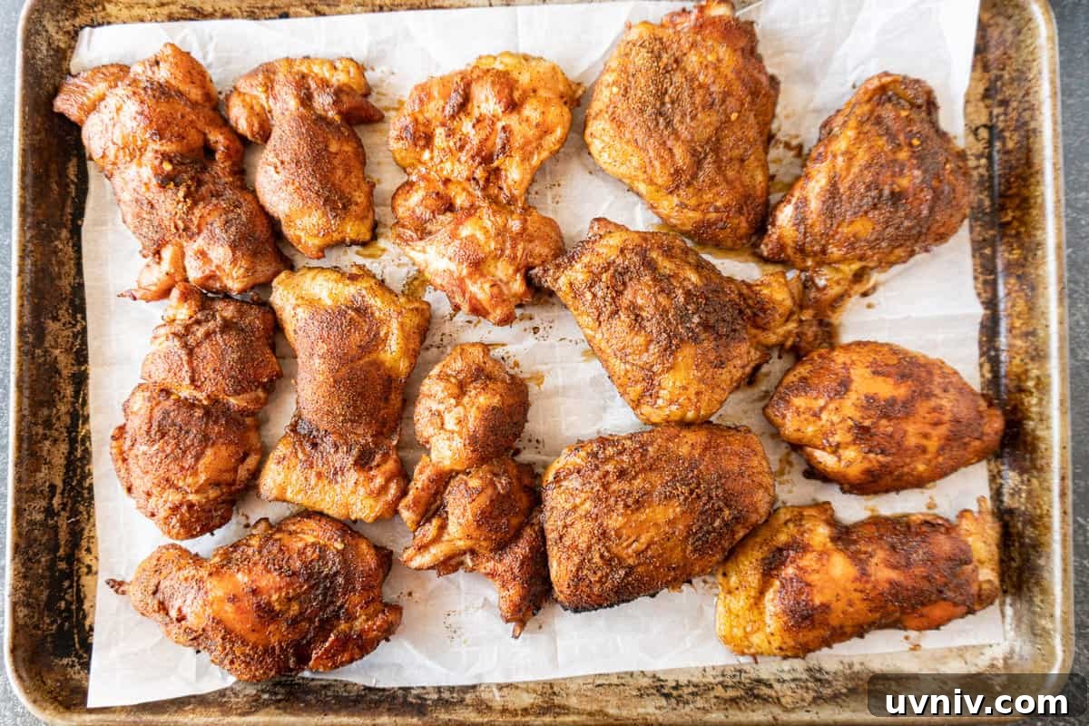 Juicy Smoked Chicken Thighs: Tender, Flavorful BBQ Recipe 11 cooked smoked chicken thighs on baking sheet