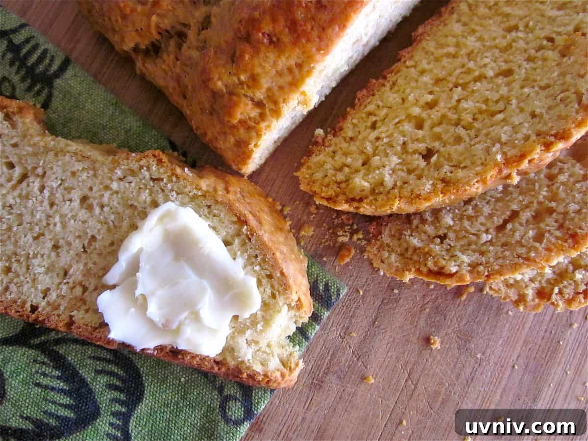 Authentic Irish Soda Bread Recipe You Can Make at Home 18 sliced Irish soda bread with butter spread on a slice.