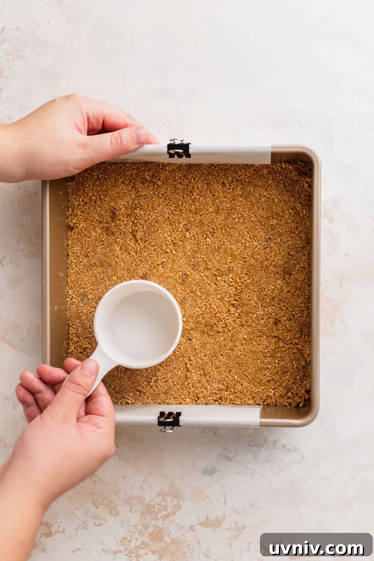 Cookie Dough Cheesecake Bars Recipe — No-Bake Dessert Bars 6 Compacting graham cracker crust into pan.