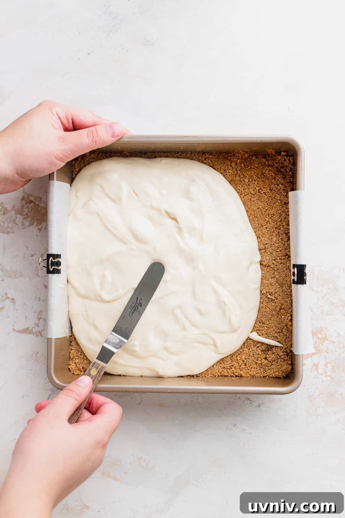 Cookie Dough Cheesecake Bars Recipe — No-Bake Dessert Bars 7 Spreading cheesecake batter on top of crust.