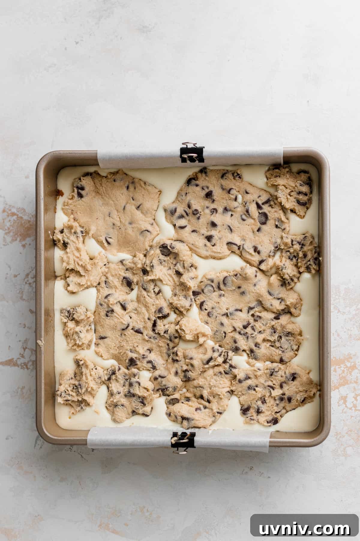 Cookie Dough Cheesecake Bars Recipe — No-Bake Dessert Bars 8 Cookie Dough on top of cheesecake batter.