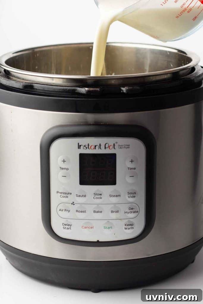 Instant Pot Yogurt Recipe: Make Yogurt with Sous Vide or Yogurt Mode 4 Milk being added to an Instant Pot.
