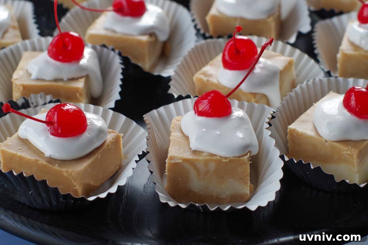 Root Beer Float Fudge Recipe: Creamy Soda-Infused Candy 2 pieces of root beer float fudge on cupcake liners, on a black try