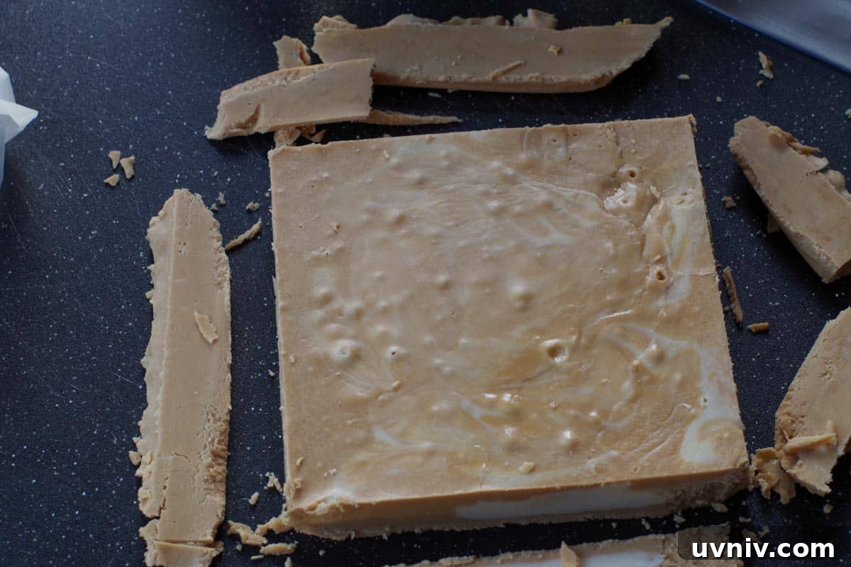 Root Beer Float Fudge Recipe: Creamy Soda-Infused Candy 16 root beer float fudge on back cutting board, with edges cut off