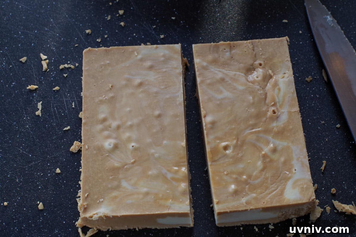 Root Beer Float Fudge Recipe: Creamy Soda-Infused Candy 17 fudge cut in half on black cutting board