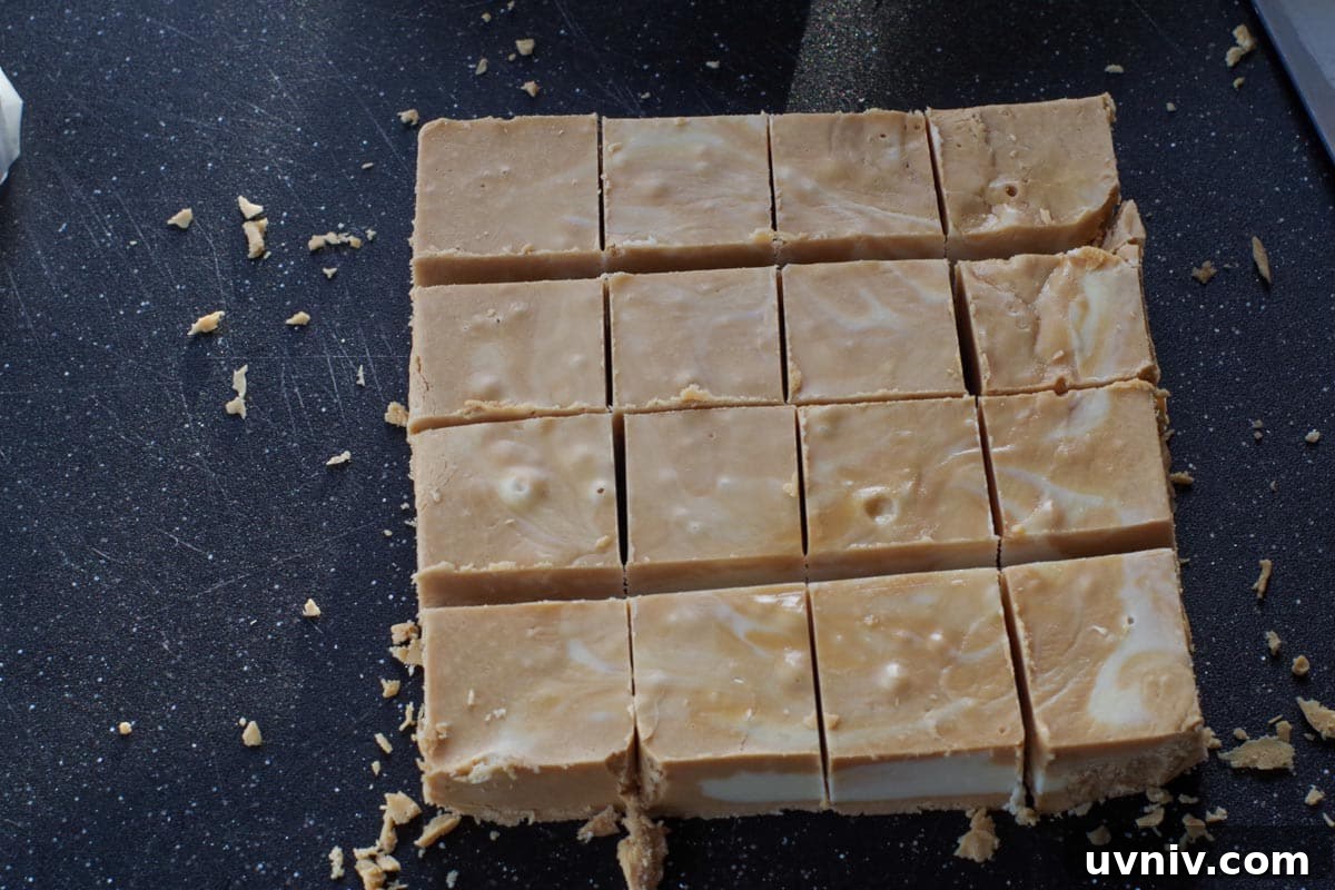 Root Beer Float Fudge Recipe: Creamy Soda-Infused Candy 18 fudge cut into 1 inch squares on a black cutting board