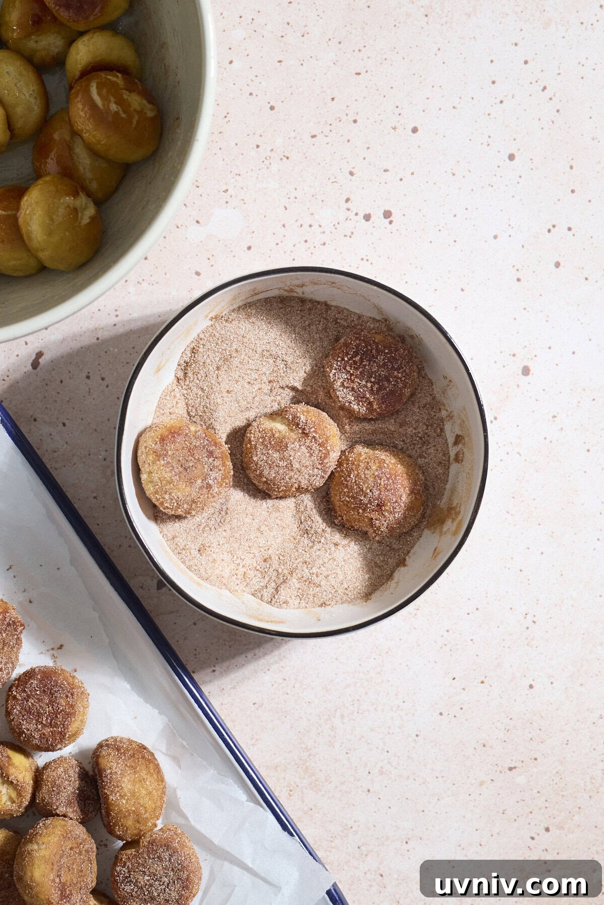 Pretzel bites being tossed in cinnamon sugar mixture.