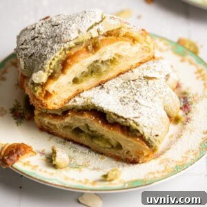Matcha Almond Croissants Recipe: Flaky Green Tea Pastry Tutorial 6 Two halves of a matcha croissant on a tea plate.