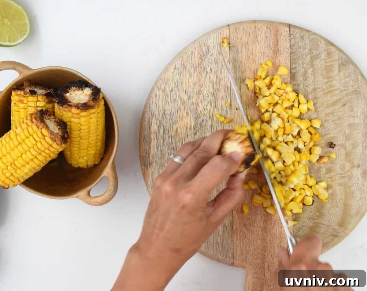 Grilled Corn and Avocado Salad with Lime Cilantro Dressing 5 Cutting kernels off grilled corn