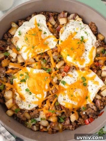 Breakfast sausage potato skillet with eggs and cheese.