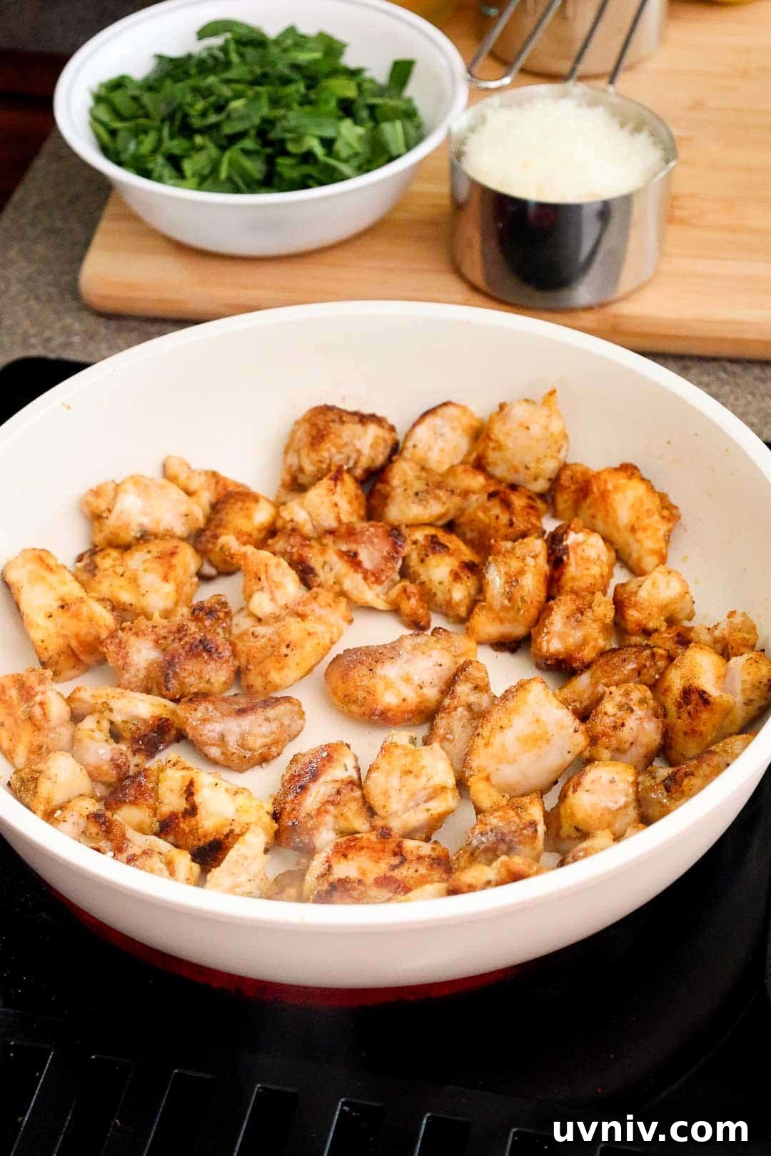 Cooked diced chicken thighs in a large skillet.