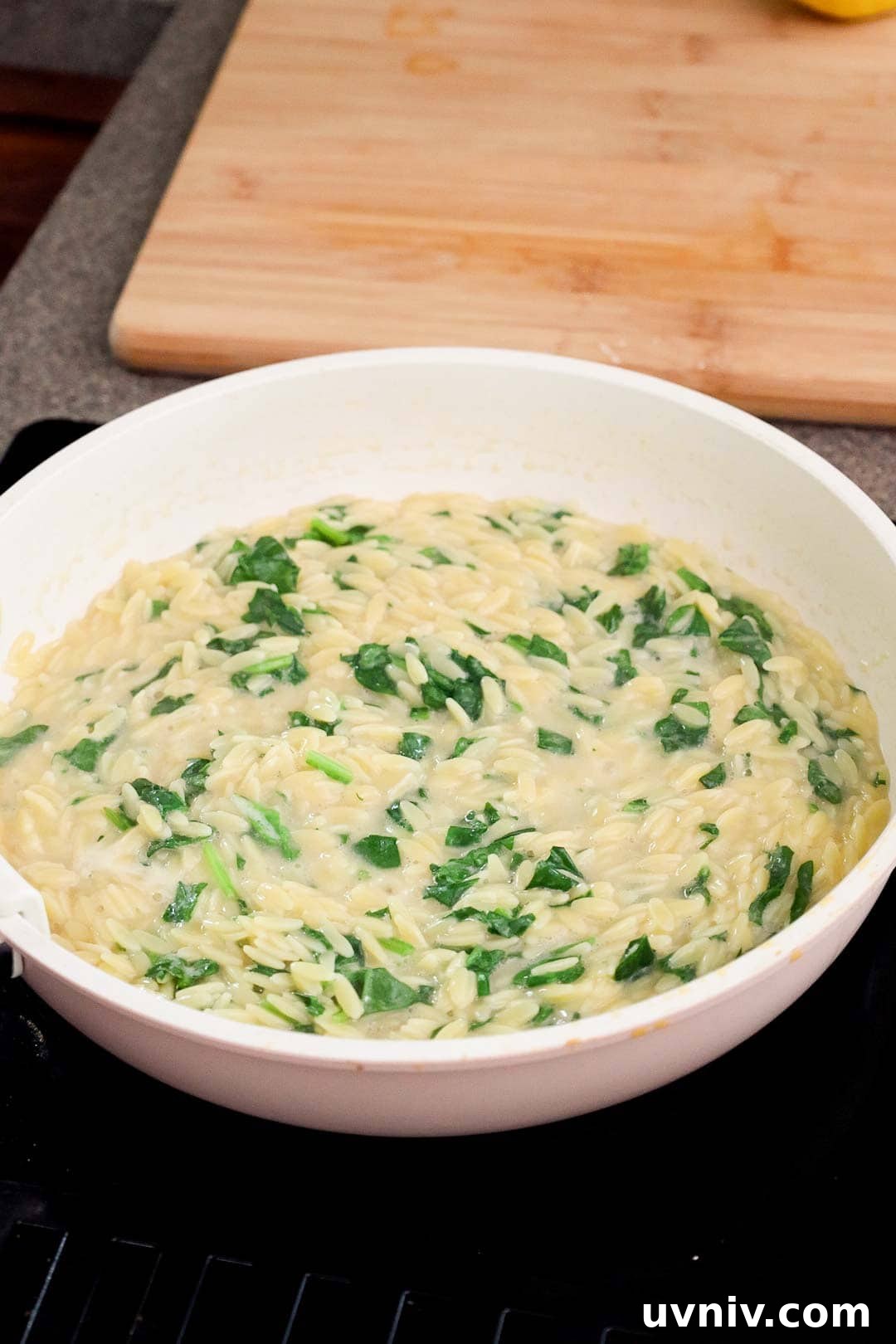 Chopped baby spinach wilted into orzo pasta.