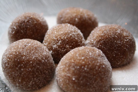 Soft, Chewy Gingerbread Cookies That Stay Tender 3 cookie dough balls rolled in sugar