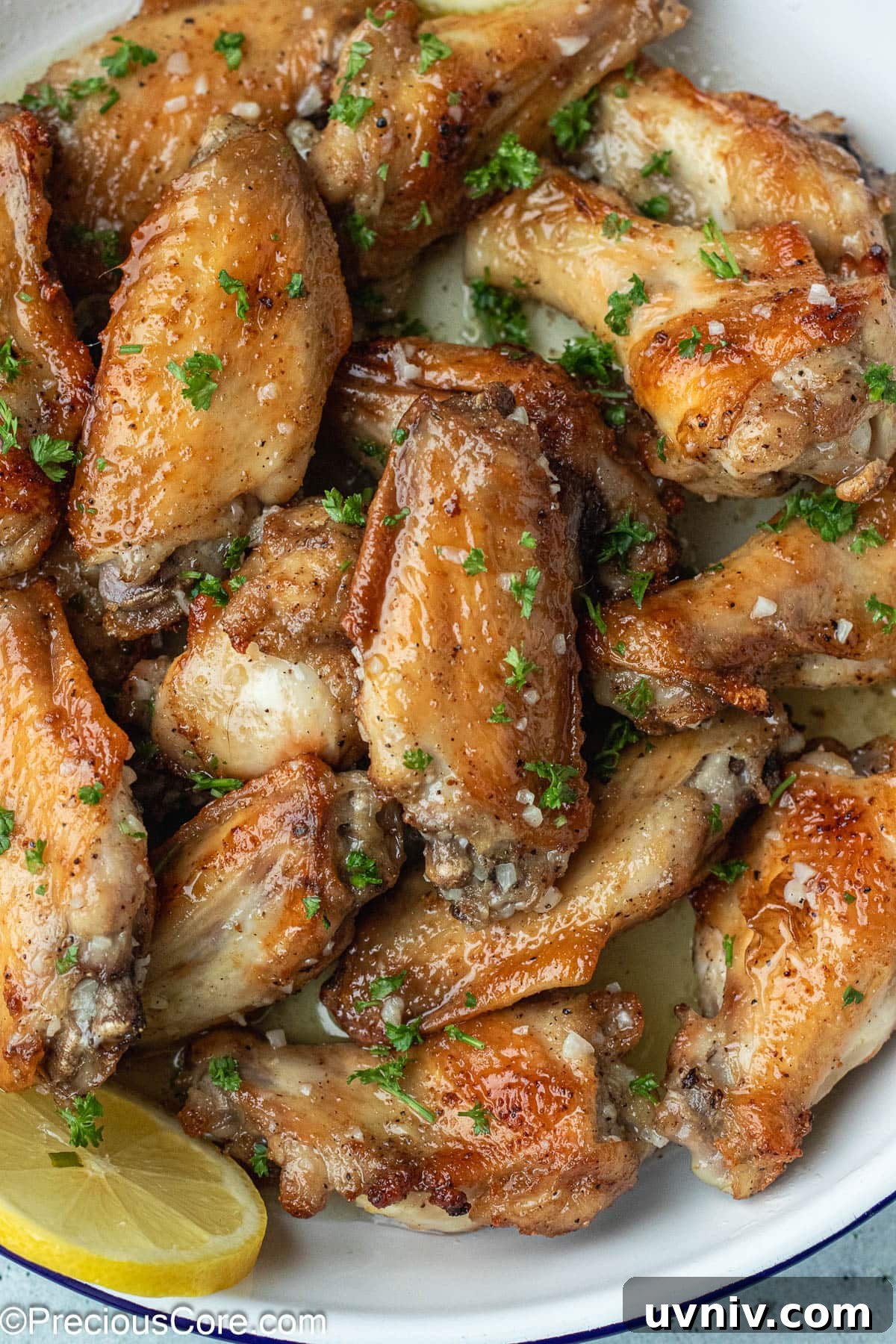 Crispy Garlic Butter Chicken Wings Recipe 2 Garlic Butter Wings in a white dish.