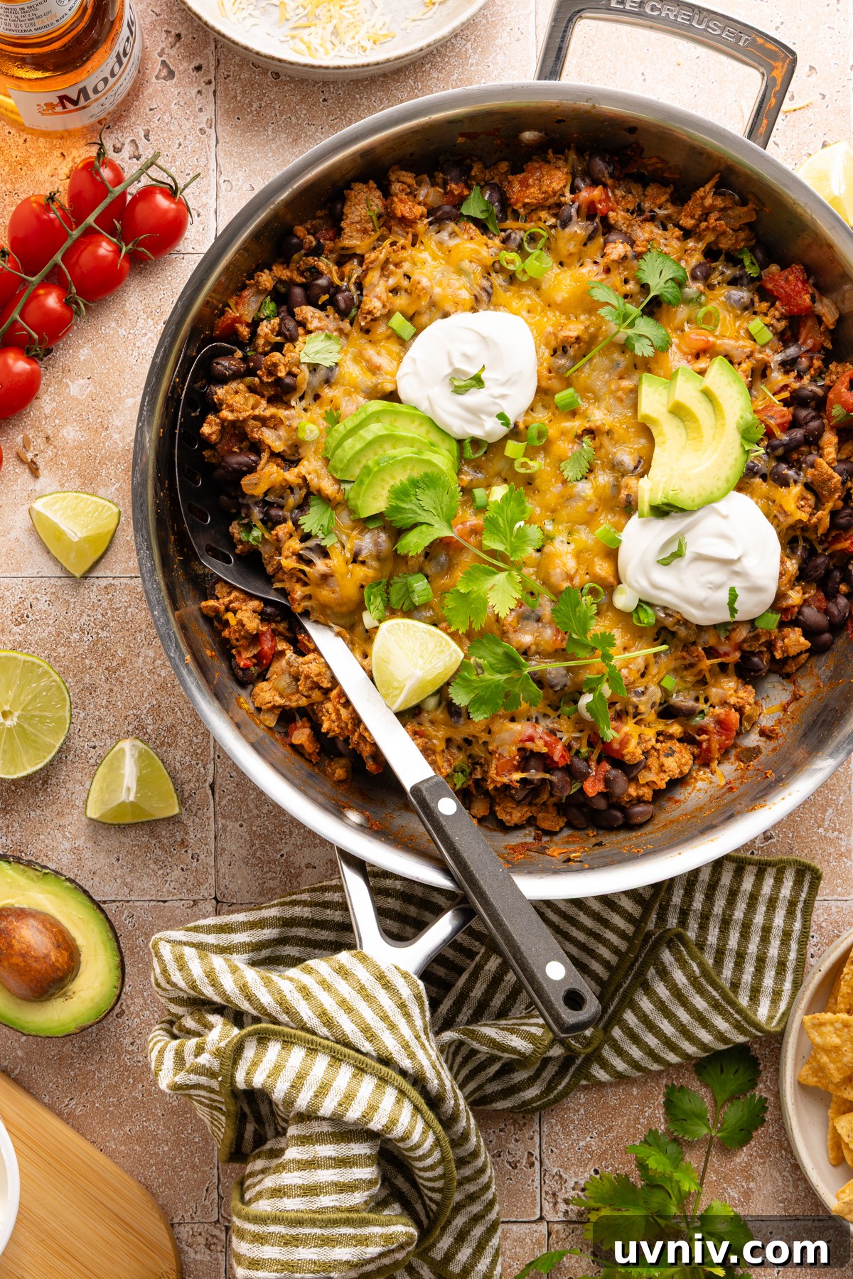 Cheesy Turkey Taco Skillet Dinner — One-Pan Weeknight Meal 2 A cheesy turkey taco skillet garnished with sour cream, cilantro and fresh avocado slices - perfect for an easy weeknight dinner