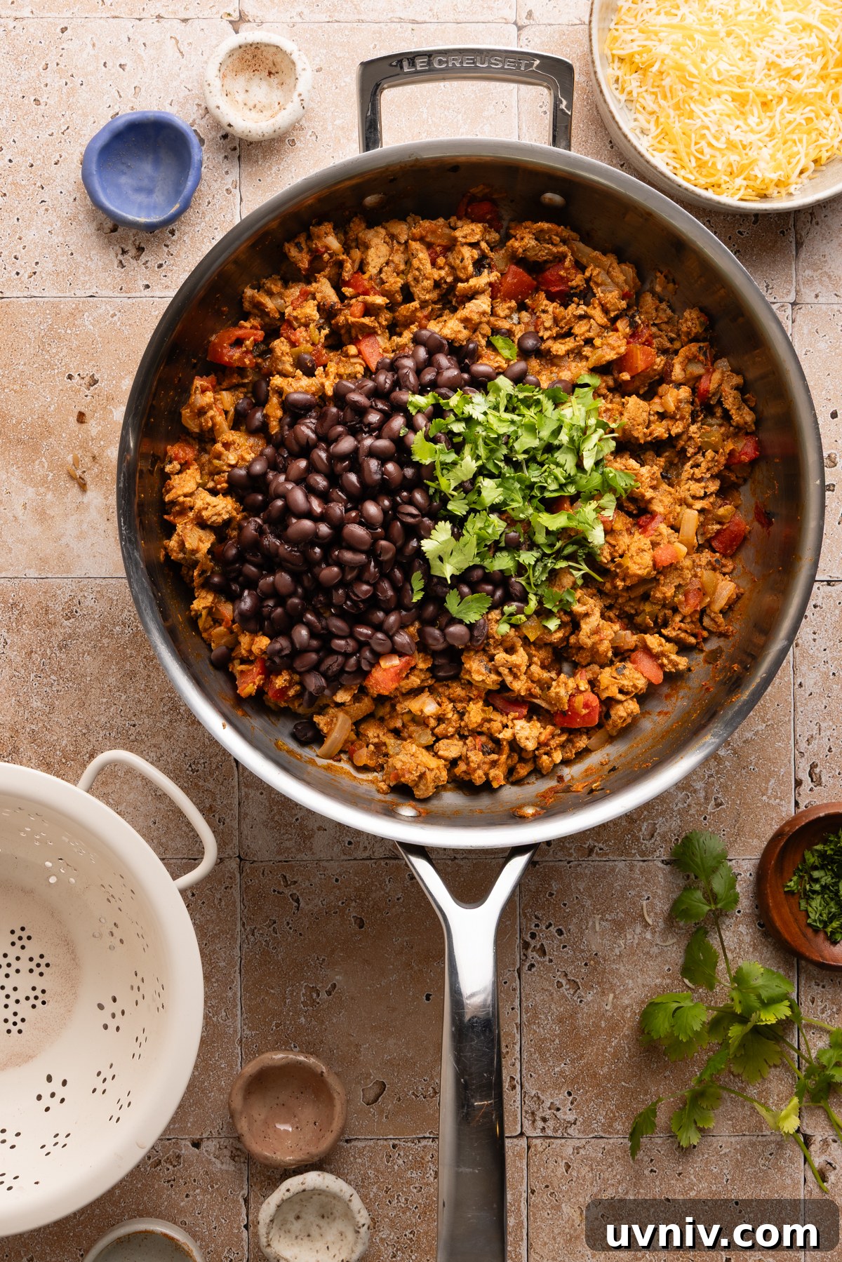 Cheesy Turkey Taco Skillet Dinner — One-Pan Weeknight Meal 9 Black beans and chopped cilantro are added to a turkey taco skillet before baking it