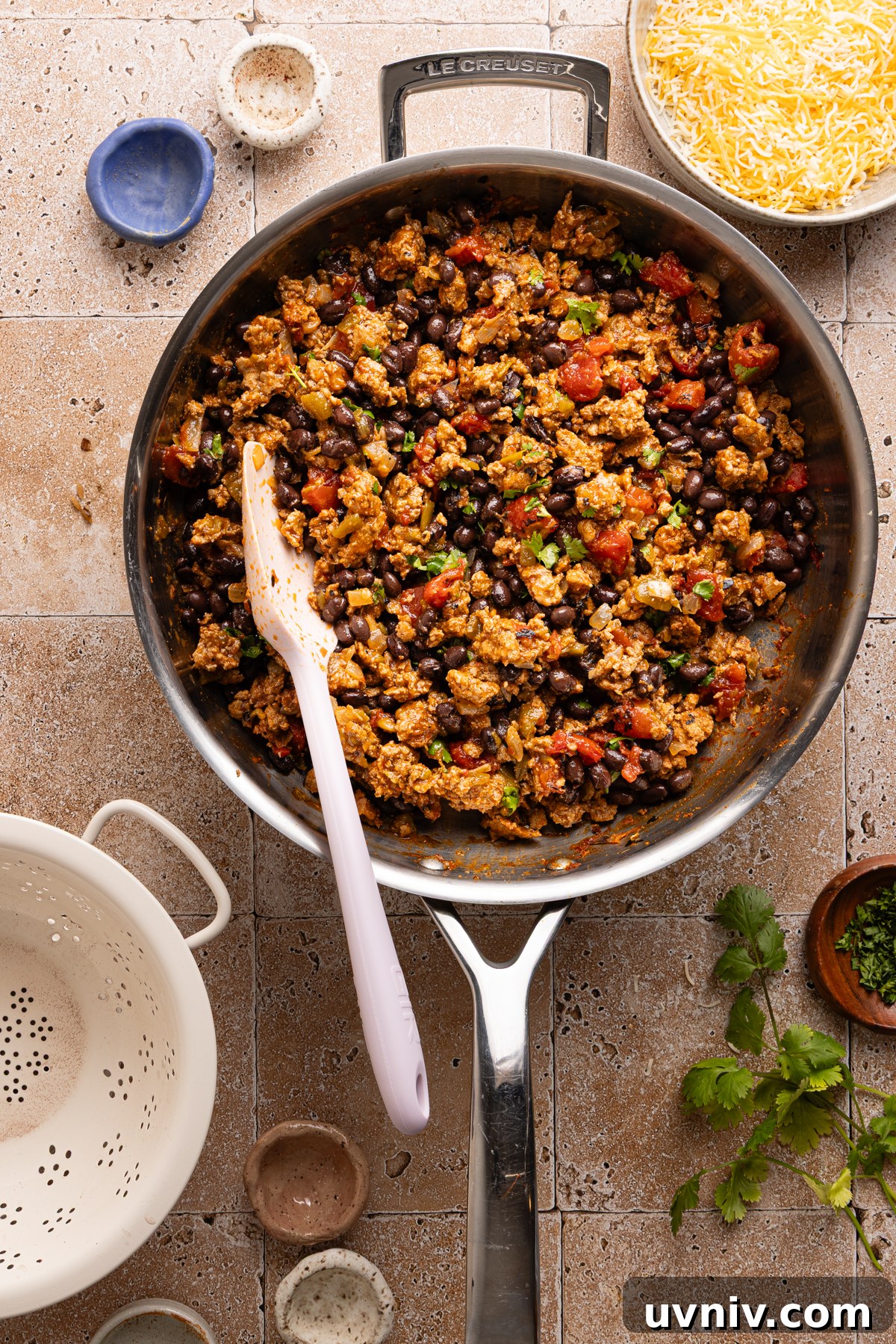 Cheesy Turkey Taco Skillet Dinner — One-Pan Weeknight Meal 10 Black beans and chopped cilantro are mixed into a turkey taco skillet before baking it